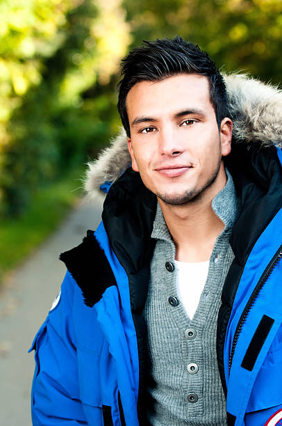 istock Happy young man wearing a parka coat 184876477