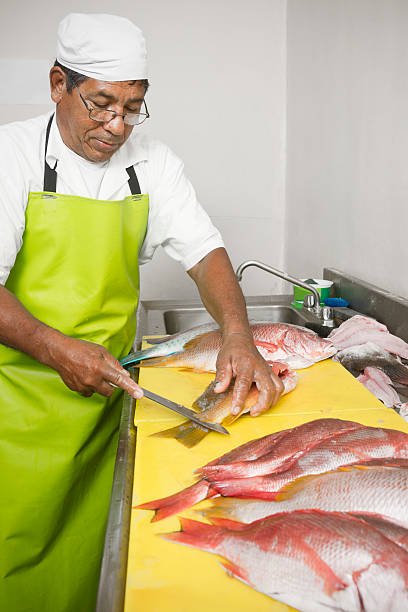 istock Cleaning fish in a fishmarket 184876824