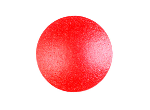 Close up of a red pill on a white background