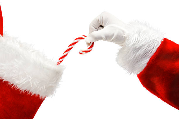 Santa Claus putting a candy cane in a stocking