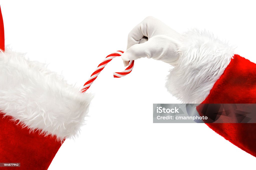 Santa Claus putting a candy cane in a stocking Santa Claus's hand placing a traditional candy cane into a Christmas Stocking against a white backgroundhttp://www.cmannphoto.com/istock/christmas.jpg Christmas Stocking Stock Photo
