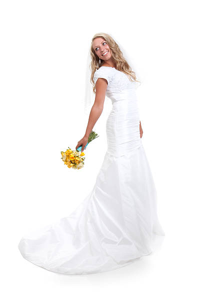 Beautiful bride on white background about to throw a yellow bouquet of flowers.