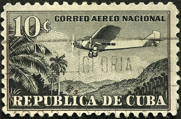 istock vintage airplane over Cuban jungle on an old postage stamp 184878040