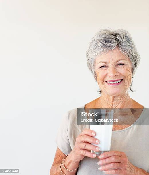 Senior Woman Holding Glass Of Milk Stock Photo - Download Image Now - Milk, Senior Adult, Drinking