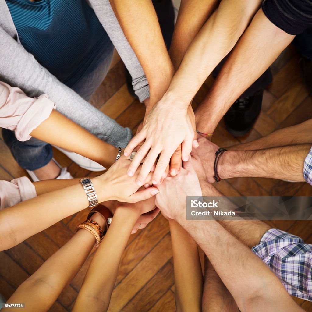 people showing unity Group of people with pile of hands Achievement Stock Photo