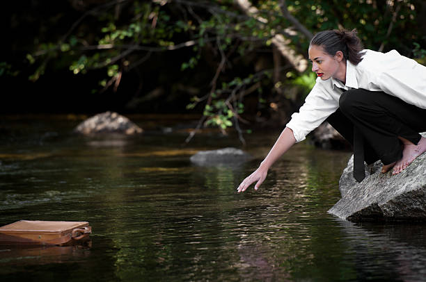 istock Young woman reaching for floating briefcase 184878880
