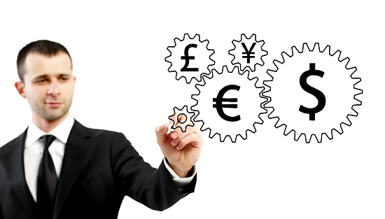 Businessman drawing gears with currency symbols on them