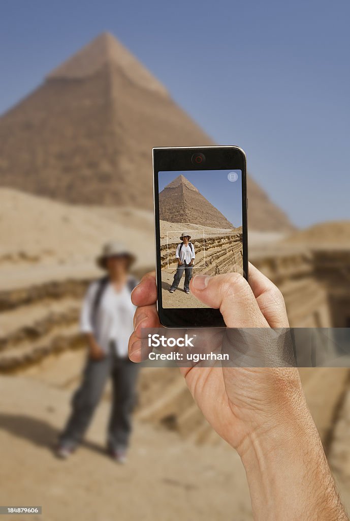 Tourist Tourist takes a snapshot of the pyramid. Africa Stock Photo