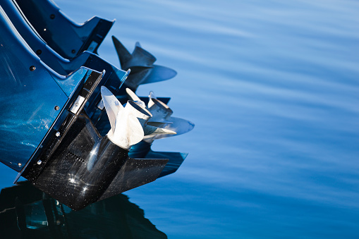 Close-up of a boat's outboard motor and propellers