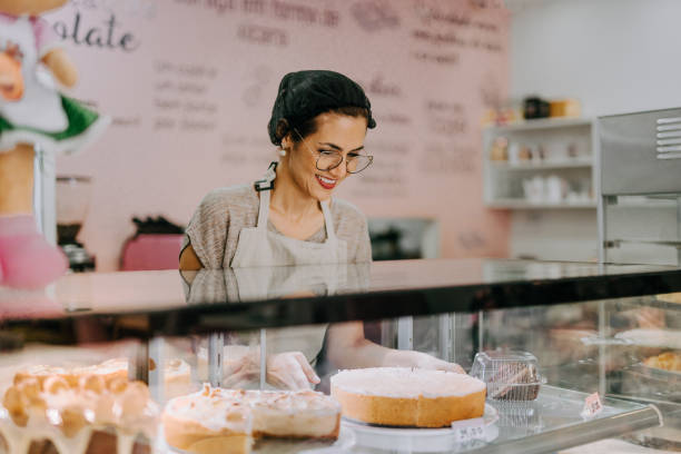 istock Pastry shop owner arranging the cake display 1848799766