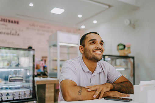 Smiling man in pastry shop/coffee shop