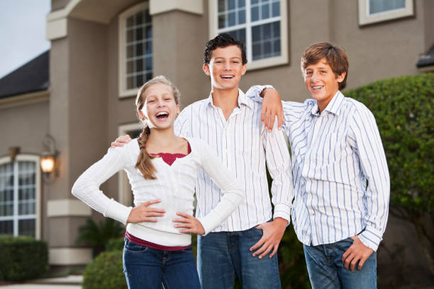 istock Family standing outside house 184880142
