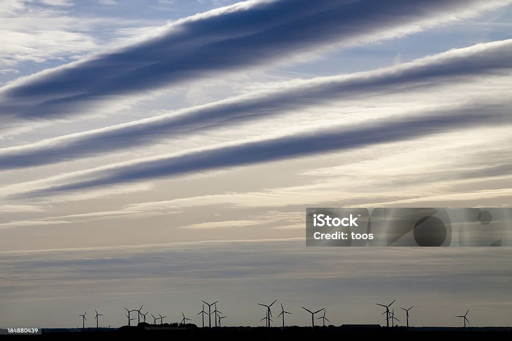 Cloudy Sky over field of Wind Turbines Agricultural Field Stock Photo