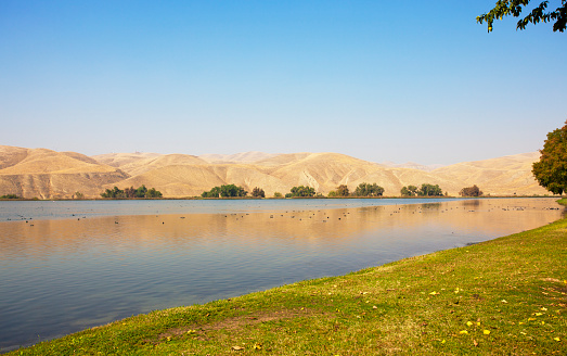 Lake Ming in Bakersfield on a warm sunny day. Lake Ming is a man-made recreational lake located in Bakersfield, California. It is primarily a motorboat and water-skiing lake, although sailboats are allowed the 2nd full weekend each month