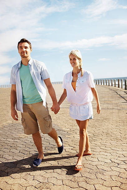 istock Beautiful couple strolling on the beach 184880822