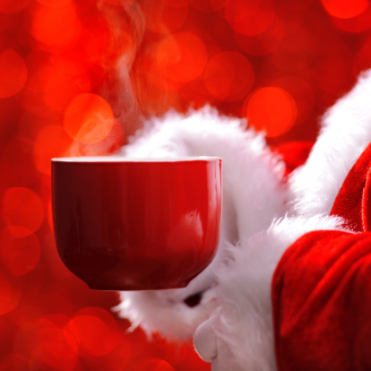 Santa holding a cup of hot drink with visible steam - XXL Image