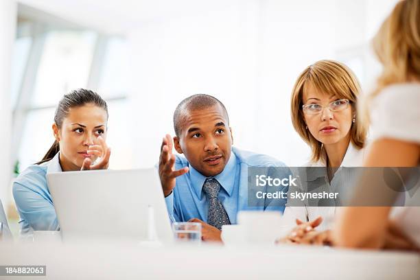 Businesspeople Working On Laptop In An Office Stock Photo - Download Image Now - Businessman, Variation, Adult