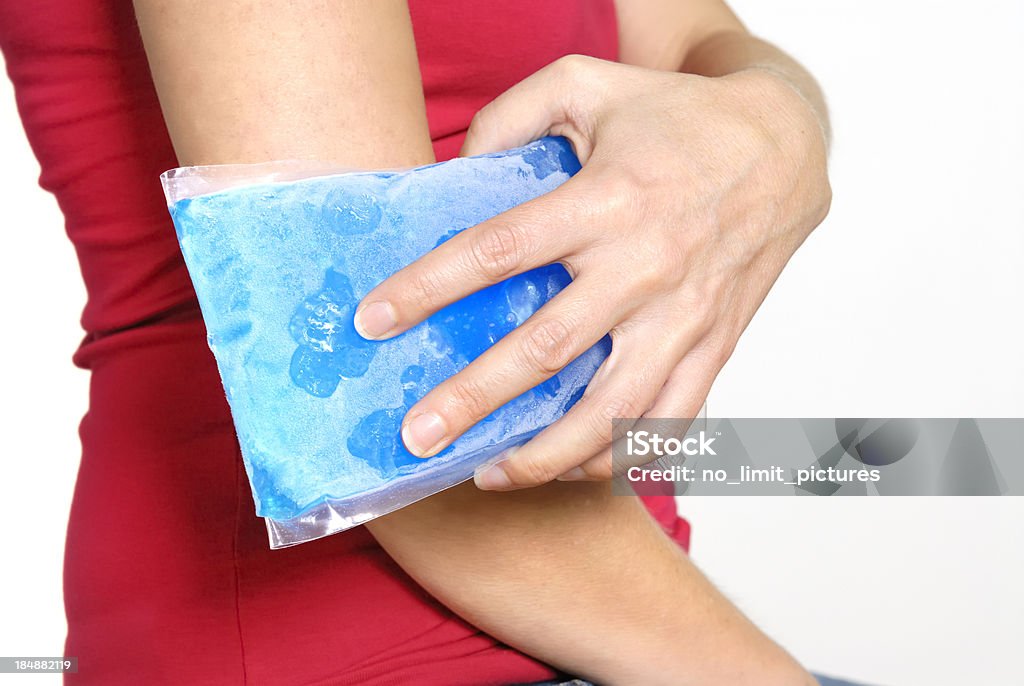 Frozen gel pack held against sore elbow "Cool gel pack on a swollen hurting elbow.doctor, pain, injury and medicine" Ice Pack Stock Photo