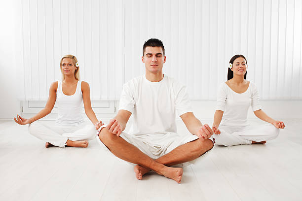 istock People are working yoga, sitting in lotus pose. 184882842
