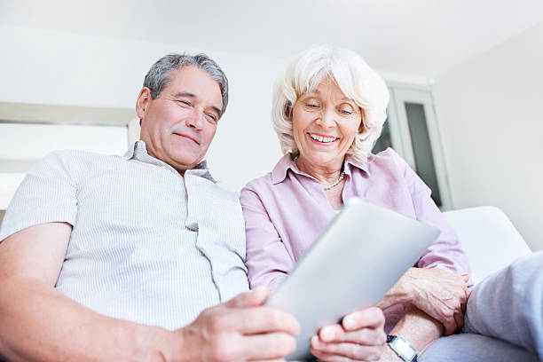 istock Smiling senior couple working on electronic tablet 184883288
