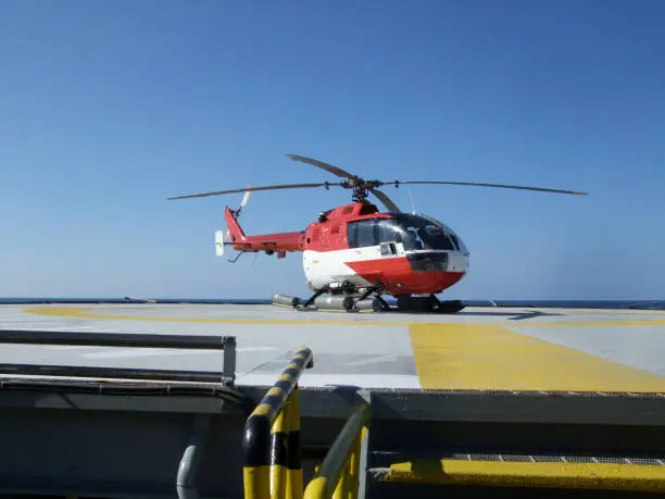 Small crewchange helicopter on an offshore oilrigs helideckMore oilfield images: