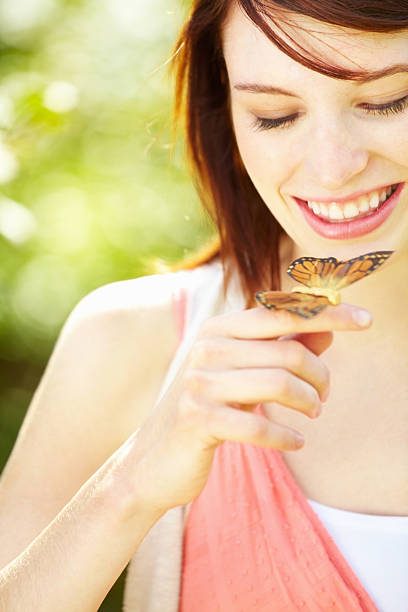 istock Young girl with a butterfly in park 184883758