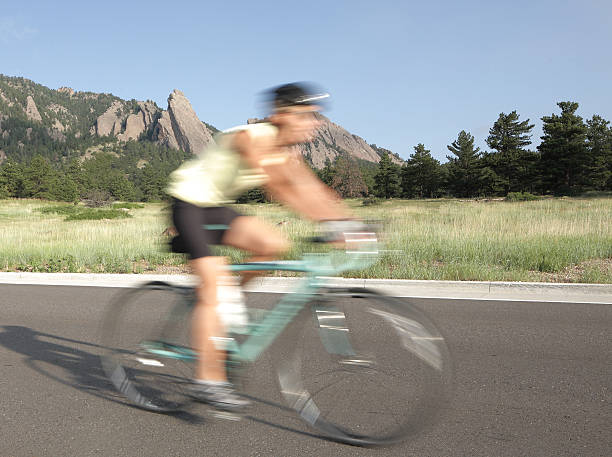 istock blurred high speed bike rider and mountains 184884288