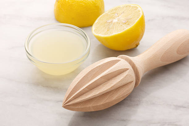 istock Lemon reamer with lemons and fresh juice 184884306