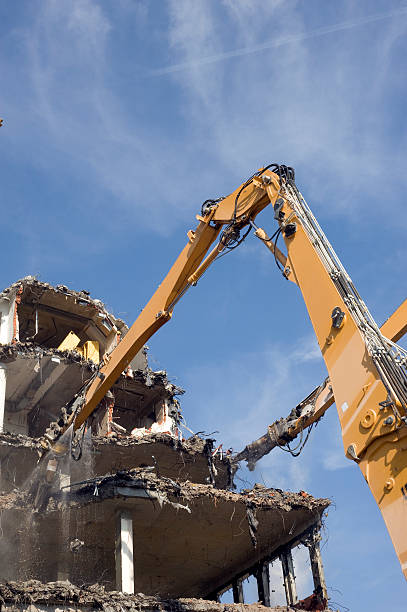 08.01.2025 Belgrade, Serbia, The demolition of the Hotel former Yugoslavia, the symbol of architecture of the `60 last century. On this place will be build a business and residential canter. Heavy machinery at construction site.