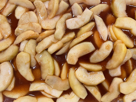 Apple pie. Cooked galette with apples on a dark background top view. French cuisine. Sweet autumn food. Homemade baking.