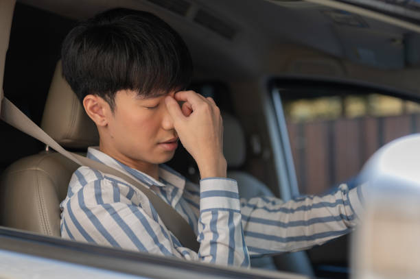 istock A tired Asian man is suffering from headaches or eye strain while driving a car for long hours. 1848849365