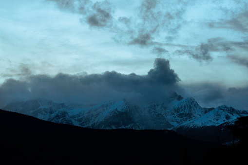 Cloud formation appears like a chimney with smoke billowing out, Columbia Icefield Parkway at dusk, Alberta, Canada