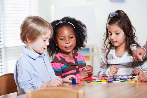 istock Preschool children in classroom using colorful shapes 184885083