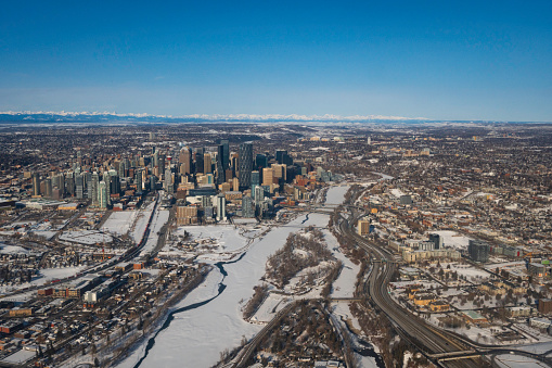 Downtown skyscrapers, highways and snowy river from the air,  Calgary, Alberta, Canada