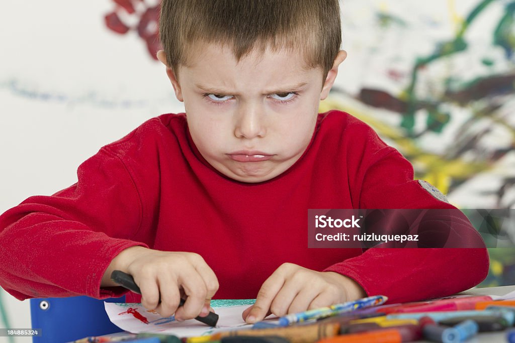 Frustrated little boy at class 4 years-old little boy painting making a face Anger Stock Photo
