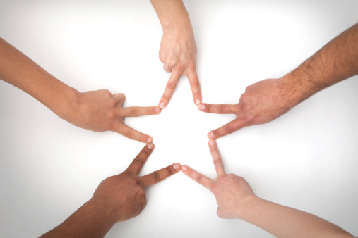 High angle view of a group of hands making a star shape.See similar images: