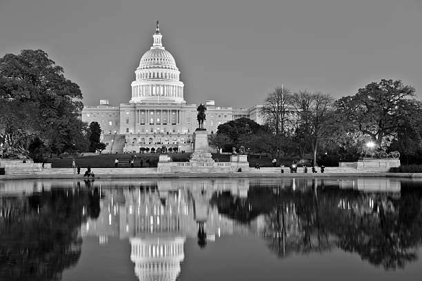 United States Capitol - Black and White with Reflection The west face of the US Capitol reflecting in the Capitol Reflecting Pool. capitol building washington dc photos stock pictures, royalty-free photos & images