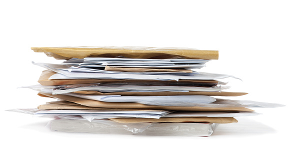 Pile of post. Envelopes,, magazines etc isolated on white with shadow