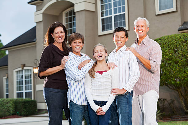 istock Big family standing outside house 184886295