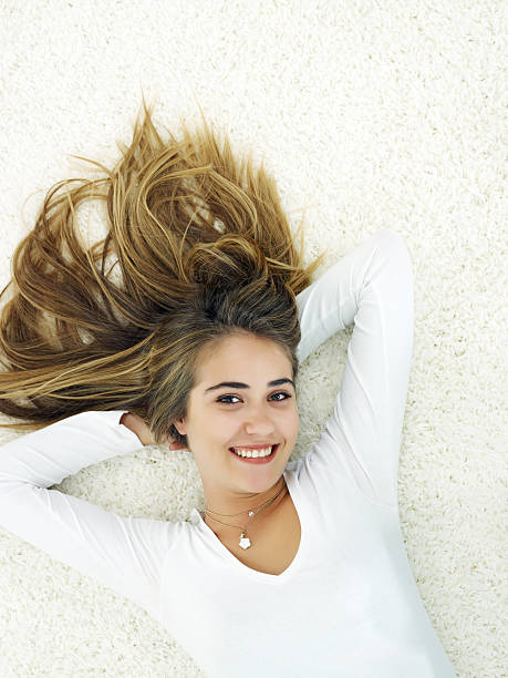 istock Young woman relaxing on carpet 184887033