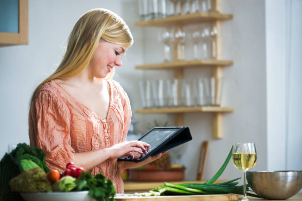 istock Young woman looking at a  Recipe online 184887096