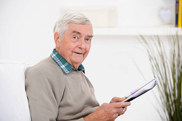 istock Close-up Of Senior Man Reading A  Magazine 184887802