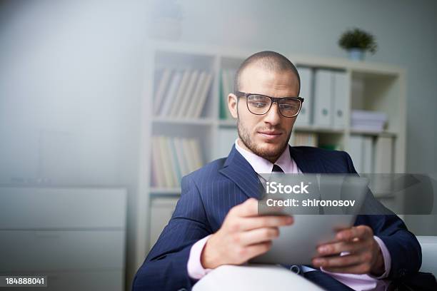 Man Using Tablet In Office Setting Stock Photo - Download Image Now - Adult, Adults Only, Beautiful People