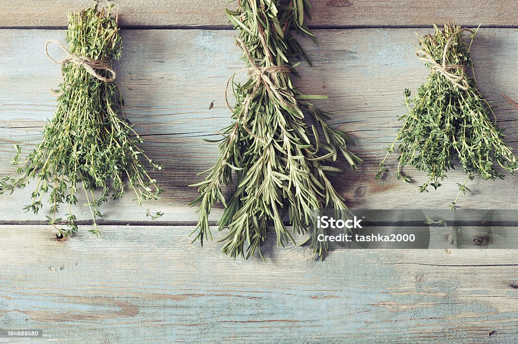 Fresh rosemary and thyme Bunchs of fresh rosemary and thyme on wooden background Backgrounds Stock Photo