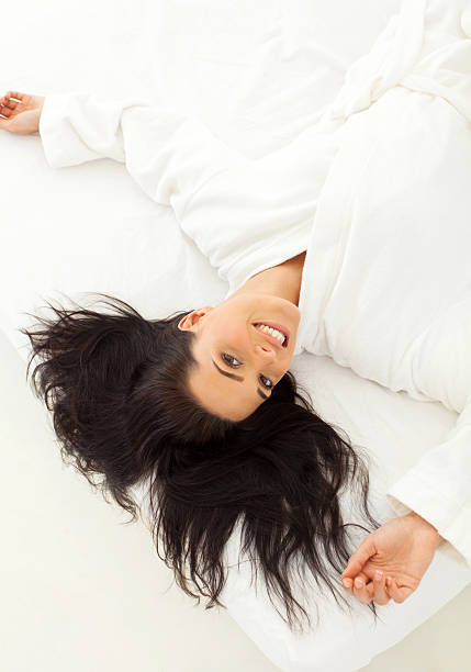 istock dark haired woman lying in bed 184888969