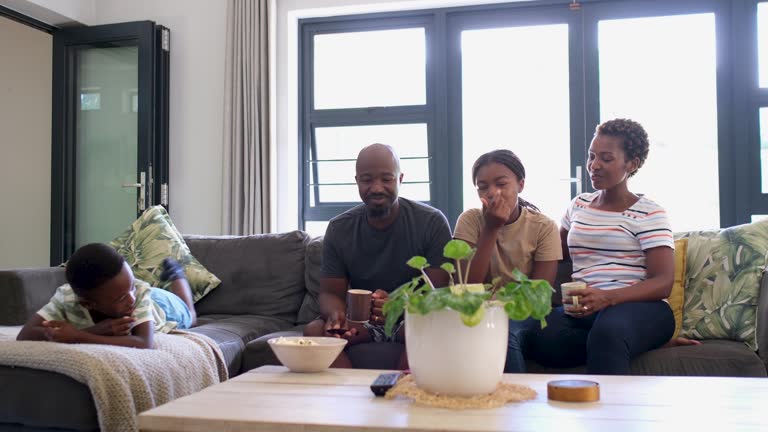 Family together on the sofa streaming their favorite TV show