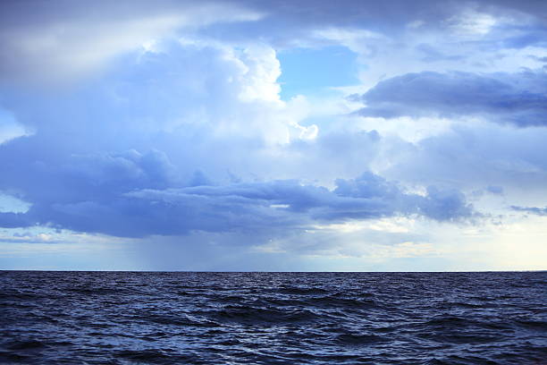 istock Cloudy dark sky above a surface of the sea 184892251