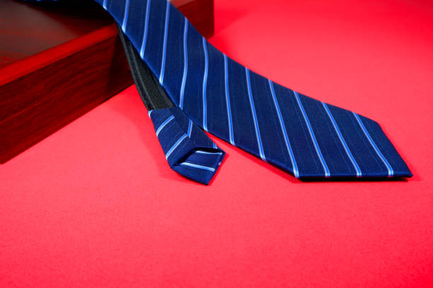istock Blue colour fabric necktie with red background 1848934008