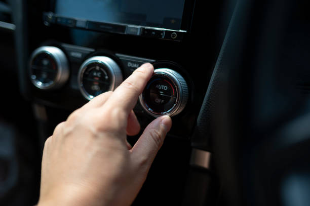istock Man's Hand Adjusting Car Air Conditioner 1848941574