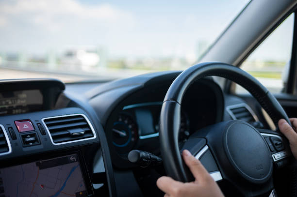 istock Man Driving a Car with Hands on the Steering Wheel 1848943119